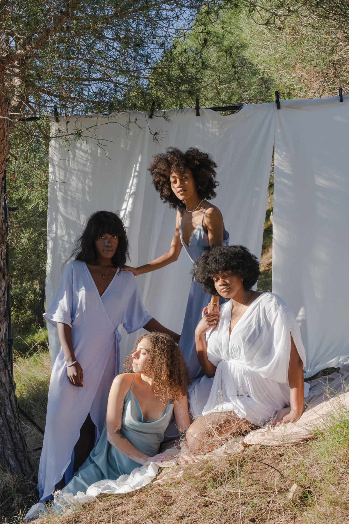 Women Posing with White Cloth in the Nature
